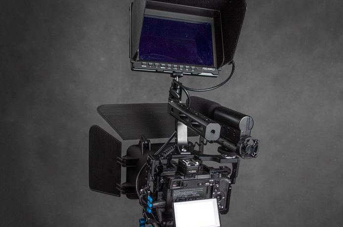 Close-up of a professional camera rig with monitor, ideal for filmmaking.