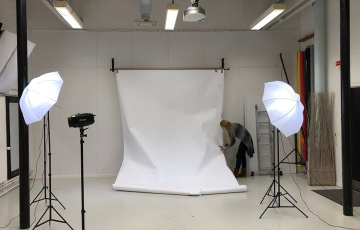 A professional photography studio setup with softbox lighting and white backdrop.