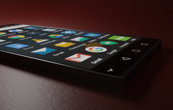 Close-up of a smartphone displaying various app icons in a low-light setting.