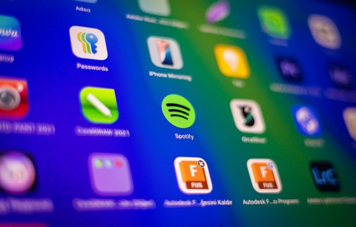 Blurred close-up of vibrant app icons on a smartphone screen showcasing Spotify and more.