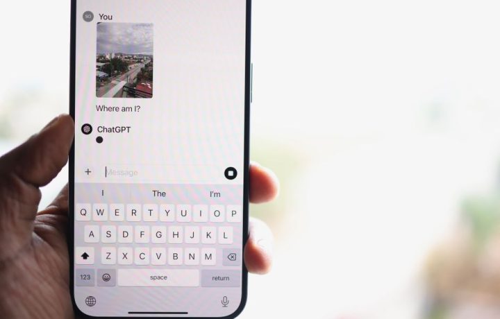 A person holds a smartphone displaying a chat with ChatGPT, inquiring about their location.