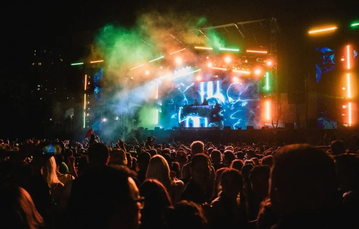 A vibrant concert scene with a lively crowd and colorful stage lights, highlighting the excitement of live events