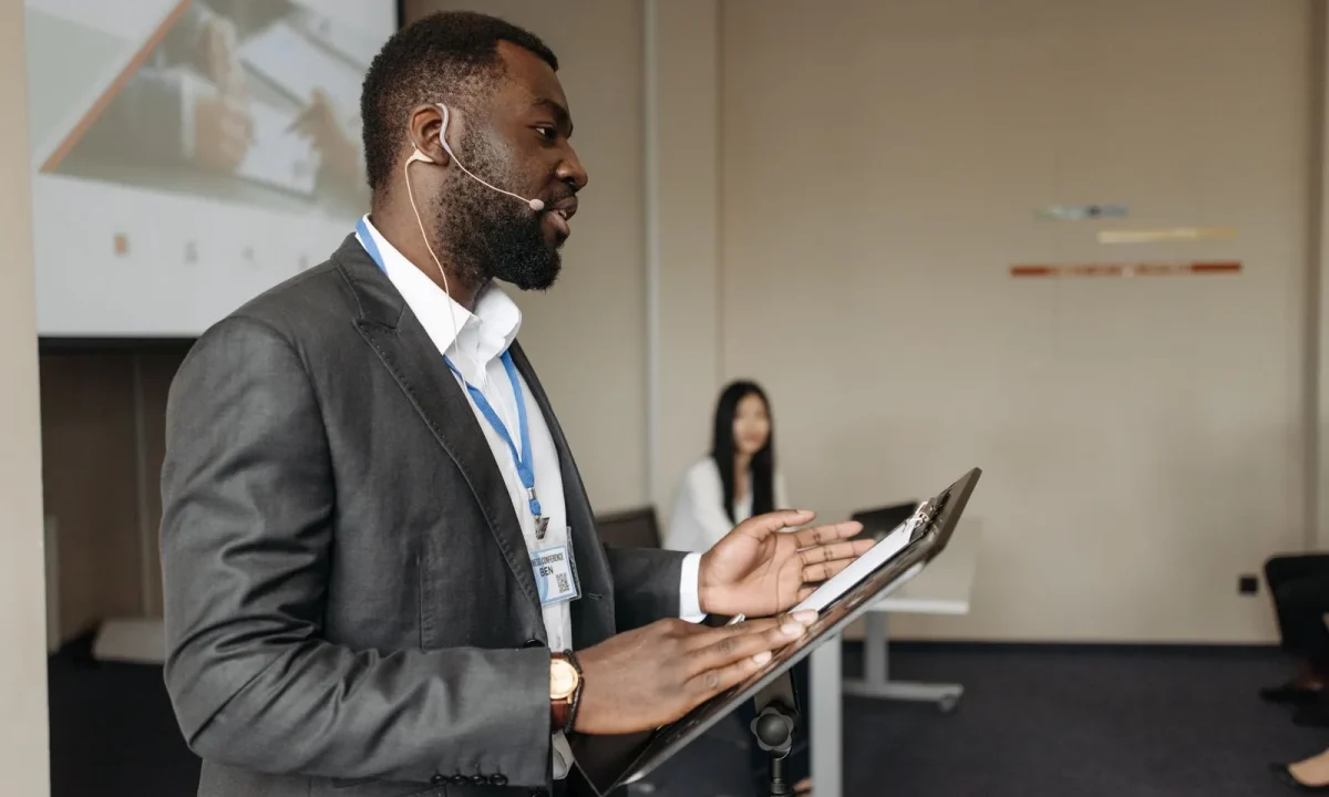 Confident speaker delivering a presentation using a teleprompter for presentations at a business conference