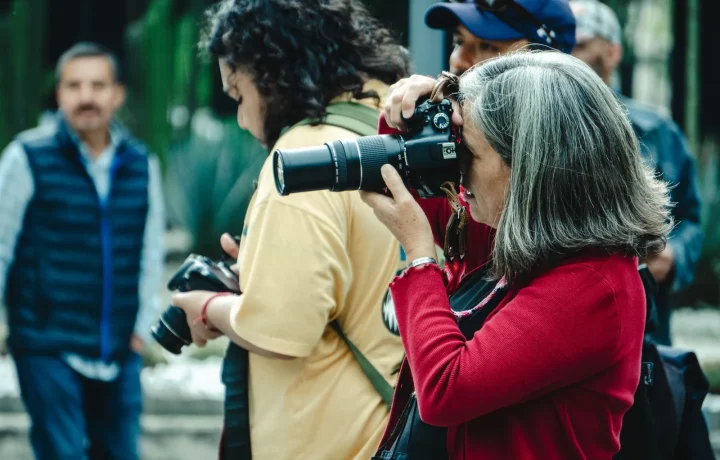 Diverse group of photographers capturing candid moments outdoors, showcasing on-camera confidence in Mexico City