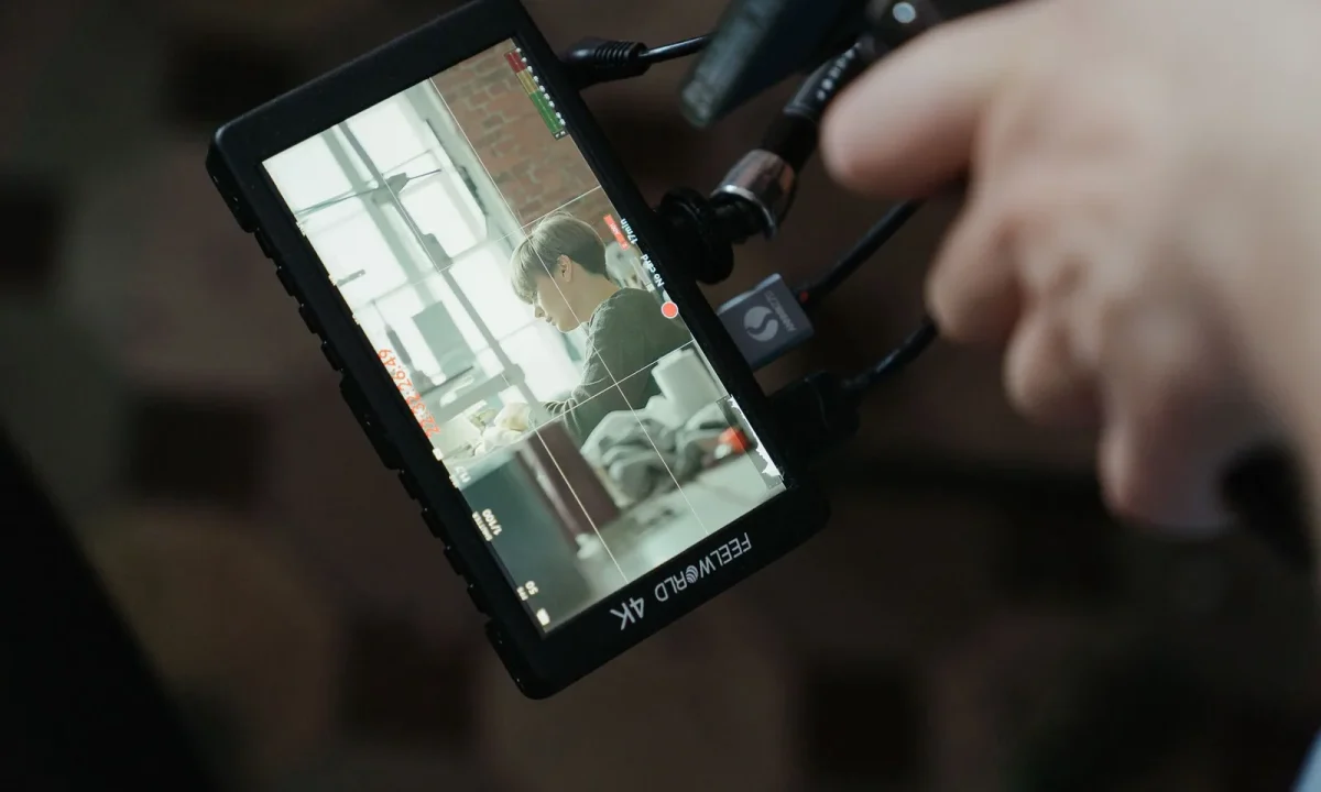 A close-up of a 4K camera screen showcasing a video shoot setup, emphasizing the use of teleprompter for video formats
