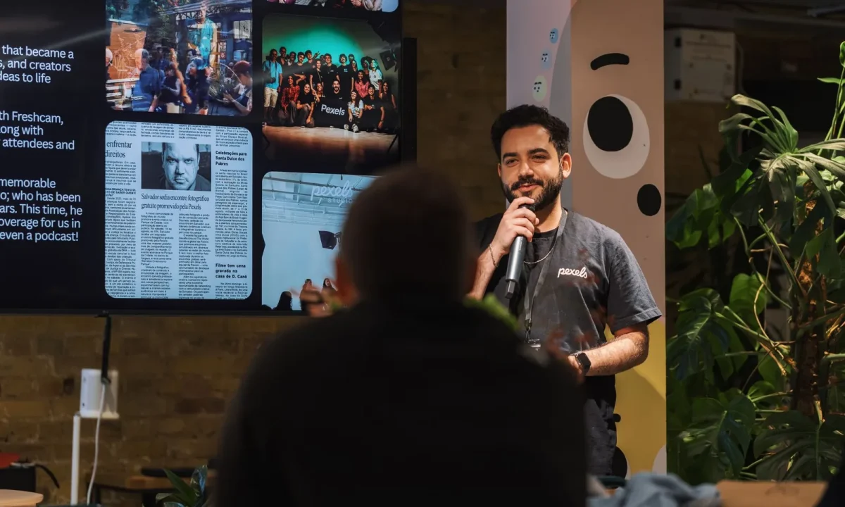 A speaker confidently engages an audience with a microphone during a lively presentation event
