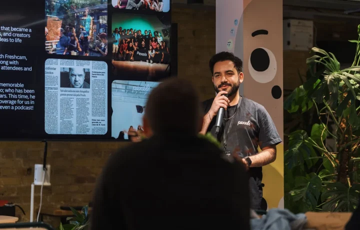 A speaker confidently engages an audience with a microphone during a lively presentation event