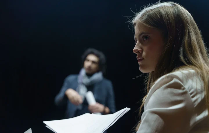 Actors rehearsing a scene, illustrating script writing for teleprompters in a theater
