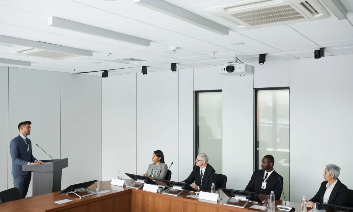 Business professionals collaborating in a modern conference room discussing the future of teleprompters