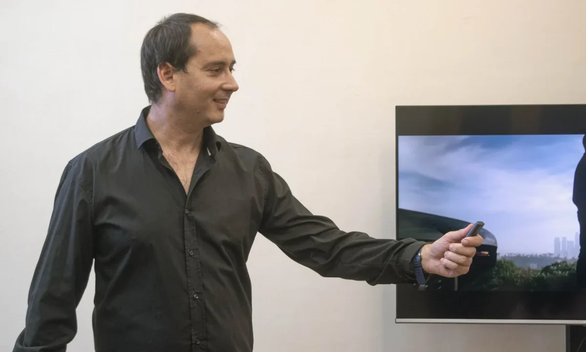 Businessman confidently presenting in an office, showcasing the future of teleprompters in action
