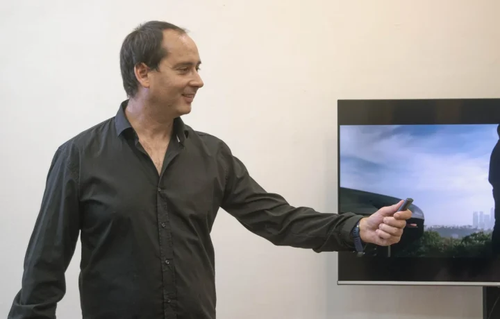 Businessman confidently presenting in an office, showcasing the future of teleprompters in action