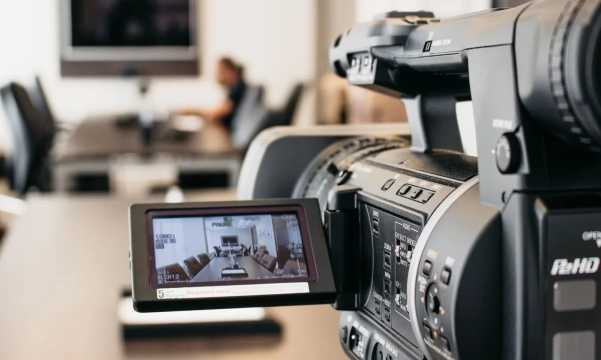 Close-up of a professional video camera recording in a modern office, illustrating the future of teleprompters