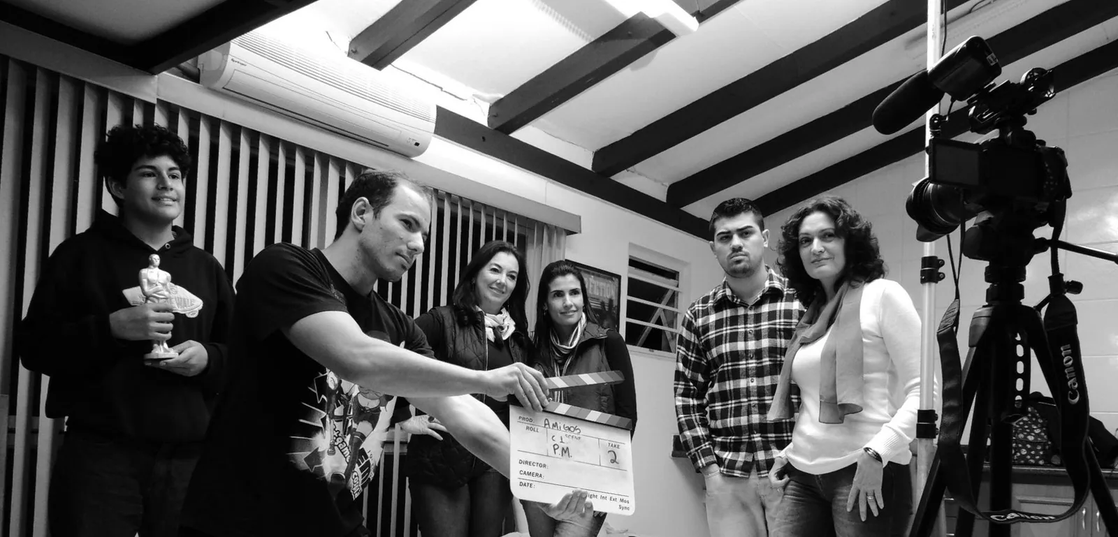 Filmmakers collaborating with a clapperboard while writing dialogue that sounds natural when read aloud