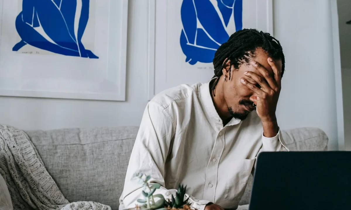 Frustrated young African American freelancer struggling with emerging teleprompter technologies while working from home