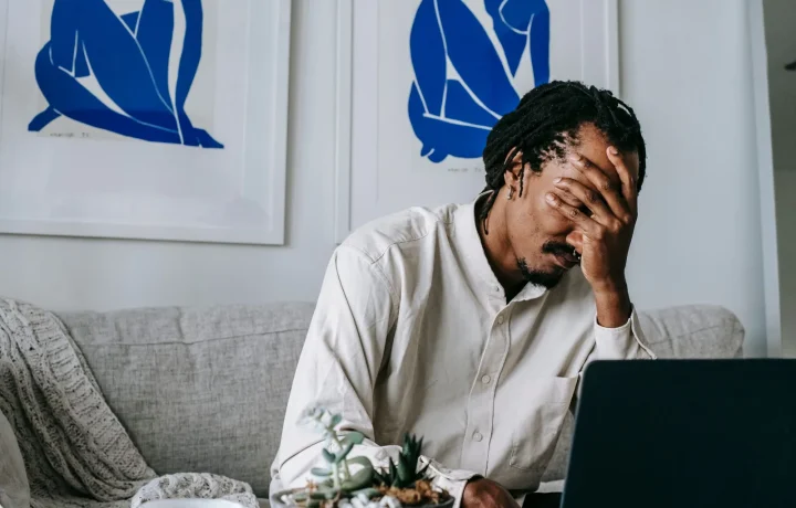Frustrated young African American freelancer struggling with emerging teleprompter technologies while working from home