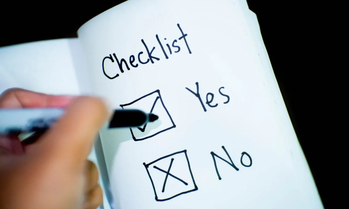 Open notebook with a checklist where one box is clearly ticked yes, highlighting essential tips to follow