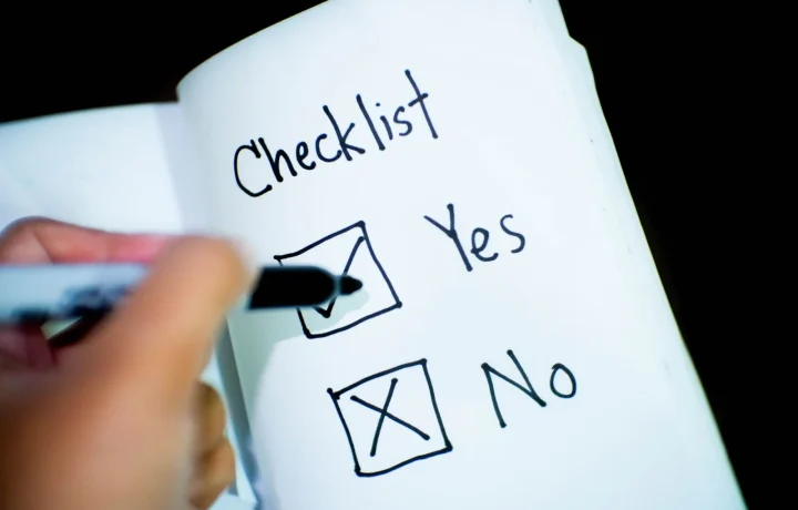 Open notebook with a checklist where one box is clearly ticked yes, highlighting essential tips to follow