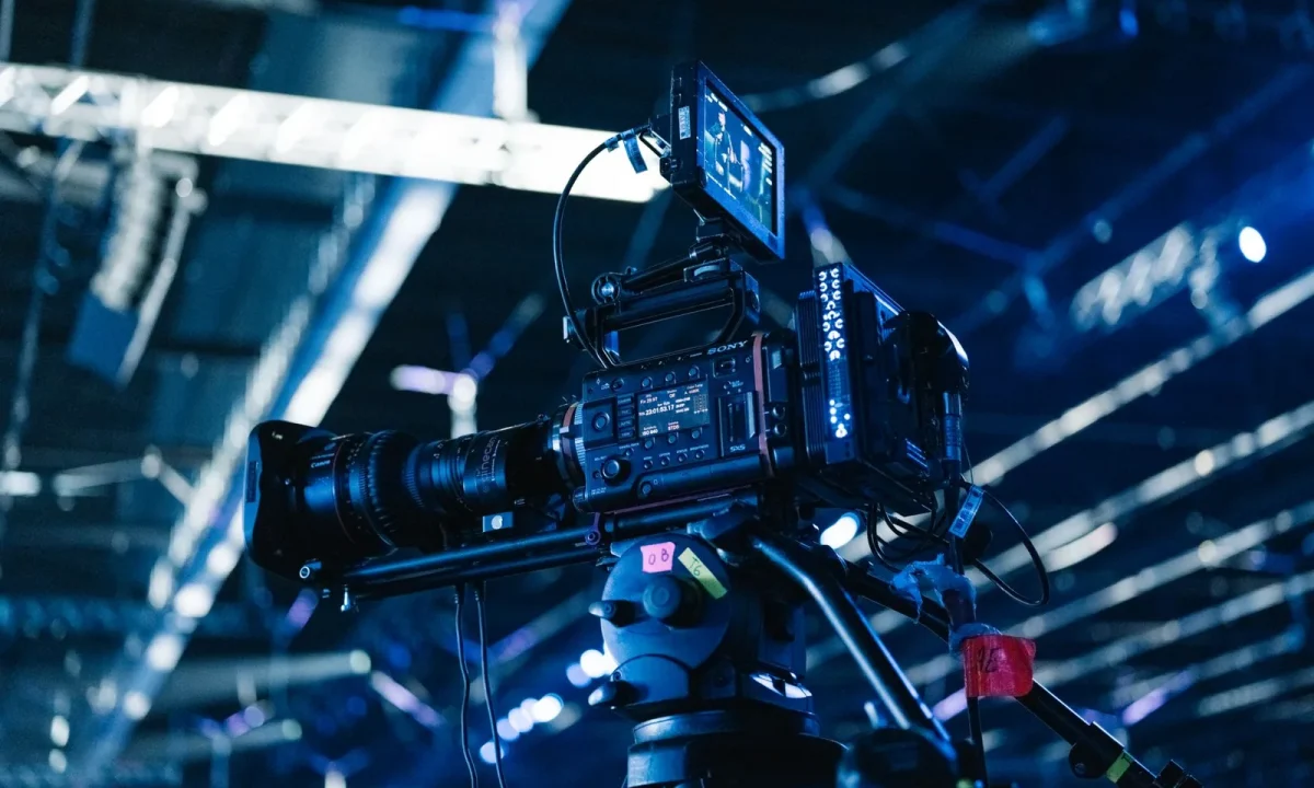 Professional video camera setup highlighting emerging teleprompter technologies in a bright indoor venue