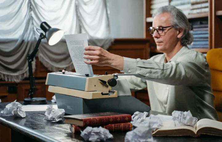 Script writing for teleprompters begins with an elderly man typing at